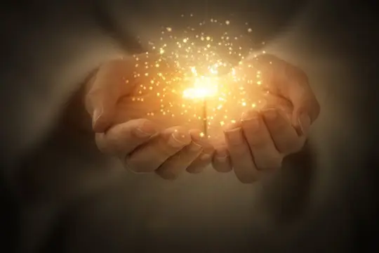 Two hands cupped together holding a glowing orb of golden light, symbolizing energy healing at Sage Holistic Arts.